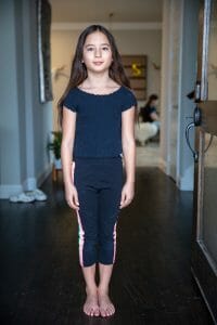Doorway Light | Kelly Williams Photography brunette girl standing straight looking forward full length | How to get your child a modeling agent in Dallas, Texas 2025