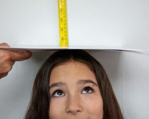 Kids blog post GIGI measure-2 | Kelly Williams Photography person measuring height of young girl | How to get your child a modeling agent in Dallas, Texas 2025