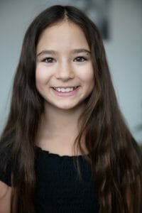 Kids blog post GIGI window light-4 | Kelly Williams Photography young girl with fake smile | How to get your child a modeling agent in Dallas, Texas 2025