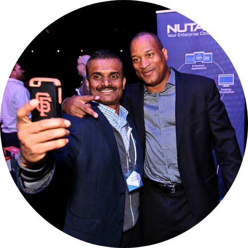Two men smiling and taking a selfie at a professional networking event in Dallas. | For Companies |